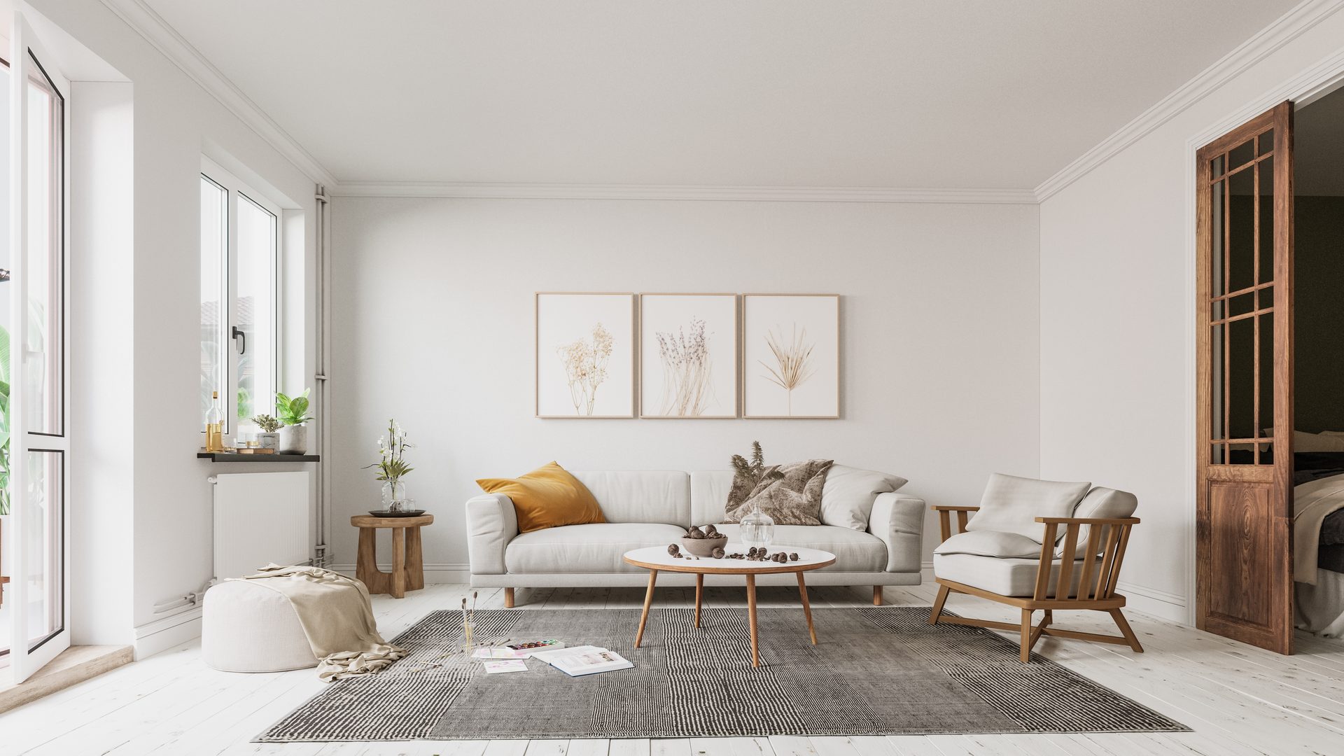A bright white lounge with painted floorboards, a cornice and tall windows, a pale sofa under three framed botanical prints and a timber glazed door open to a bedroom
